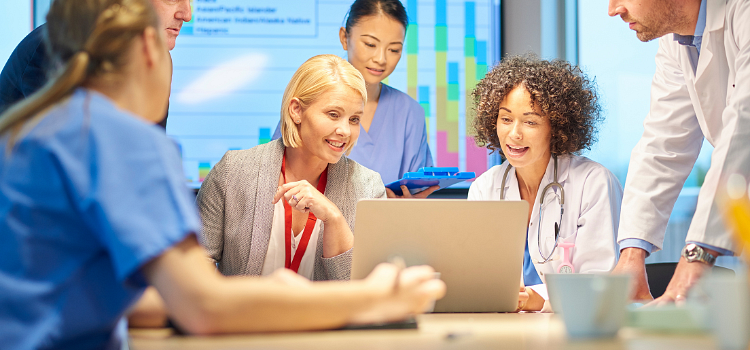 Medical team looking at a laptop